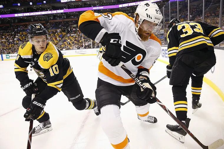 Philadelphia Flyers’ Jakub Voracek (93) battles Boston Bruins’ Anders Bjork (10) and Zdeno Chara (33) for the puck during the first period of a preseason NHL hockey game in Boston, Thursday, Sept. 21, 2017.
