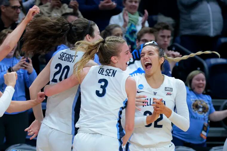 Villanova players celebrate their victory over Florida Gulf Coast to advance  in the Women's NCAA Tournament.at the Finneran Pavilion at Villanova University on March 20, 2023. L-R:  Maddy Siegrist, Lucy Olsen, and Bella Runyan.