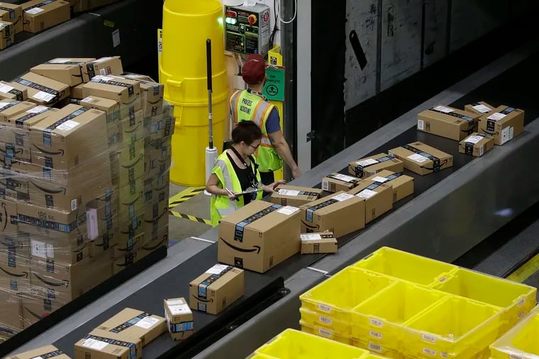 In this Feb. 9, 2018, file photo packages move down a conveyor system were they are directed to the proper shipping area at the new Amazon Fulfillment Center in Sacramento, Calif. (AP Photo/Rich Pedroncelli, File)