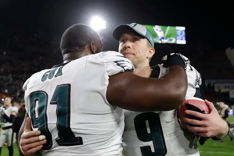 Nick Foles embraces Fletcher Cox after the Eagles' win over the Rams on Sunday.