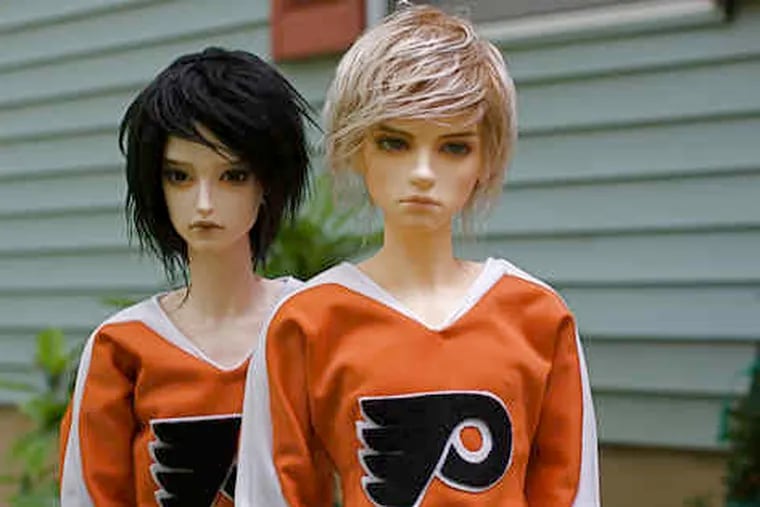Baz (left) and Sergei are Asian dolls created by hairstylist Jody Rabenau, of Phoenixville, who says the Flyers are more successful when she's watching games while sewing doll clothes than when her hands are idle.