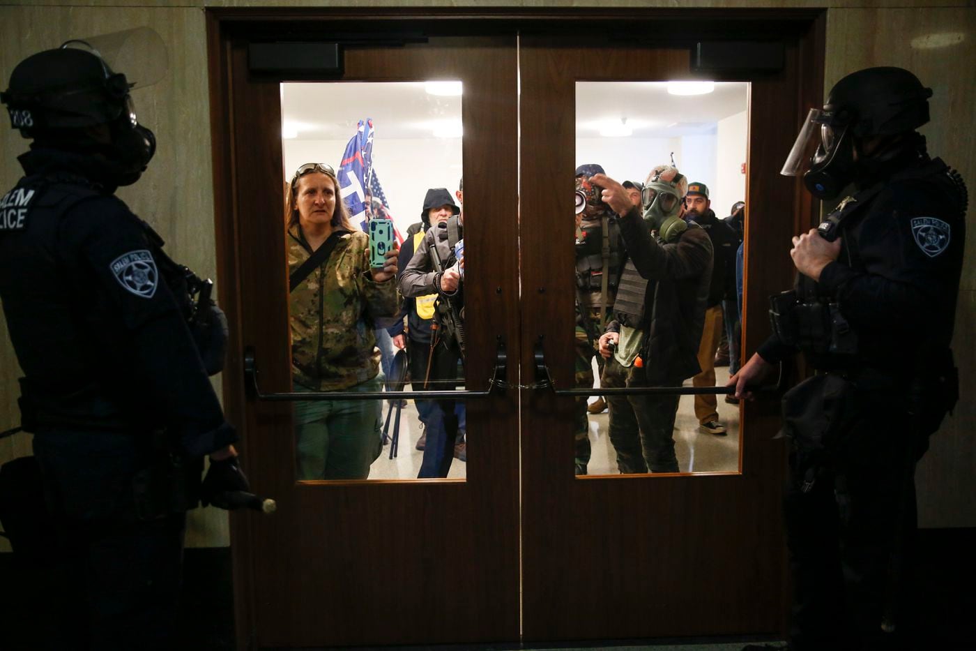 Right-wing protesters try to get into the Oregon State Capitol during a special session on Monday, Dec. 21, 2020 in Salem, Oregon.
