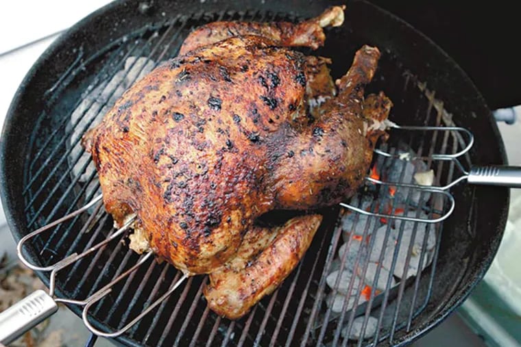 Craig LaBan uses a Weber charcoal grill to cook a Thanksgiving turkey.