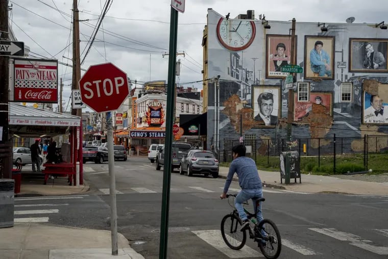 Across from Pat’s King of Steaks, a grassy, vacant lot, pictured on the right, has sat untouched for years. Now, residents are fighting over what should be built there.