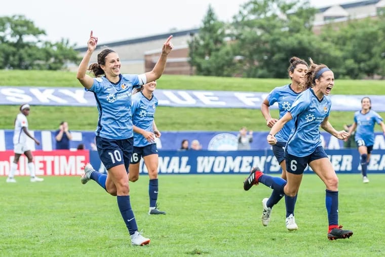 Carli Lloyd celebrates after scoring the game-winning goal for Sky Blue FC against the Orlando Pride.