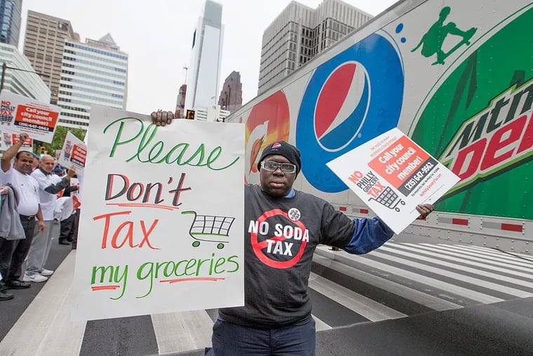 Members of Philadelphians Against the Grocery Tax Coalition rally outside City Hall.