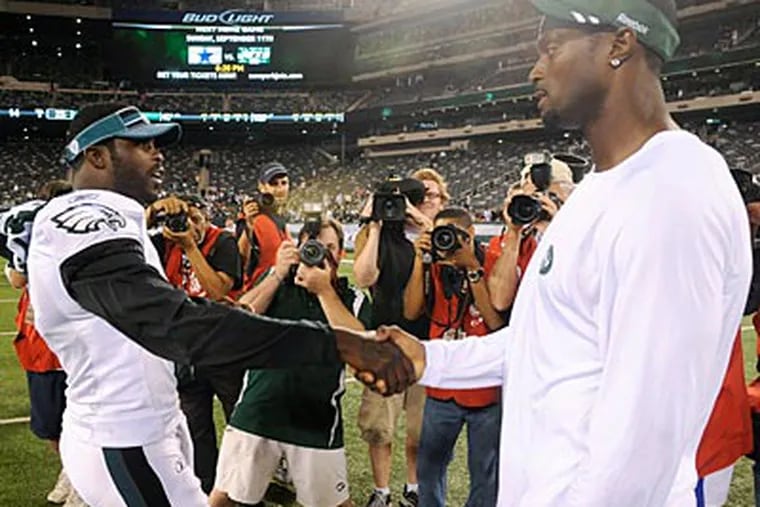Plaxico Burress and Michael Vick will both be on the field in Philadelphia on Sunday as free men. (Bill Kostroun/AP)