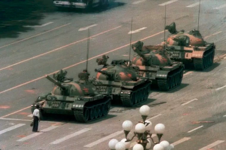 In this June 5, 1989, file photo, a Chinese man stands alone to block a line of tanks heading east on Beijing's Cangan Blvd. in Tiananmen Square. The man, calling for an end to the recent violence and bloodshed against pro-democracy demonstrators, was pulled away by bystanders, and the tanks continued on their way. Thousands of students demonstrated for democracy in Tiananmen Square. Hundreds died when the government sent in troops.