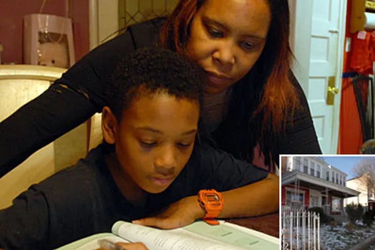 Donita Bagner helps her adopted son Bryan Drummond with his homework in her home. (Ron Tarver / Staff Photographer)