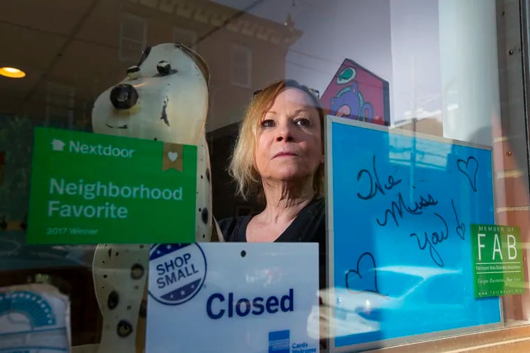 Kathleen Owens stands at the front window of Bow Wow & Meows on North 24th Street. Philadelphia pet groomers are struggling to understand why they must be closed amid the coronavirus shutdown.