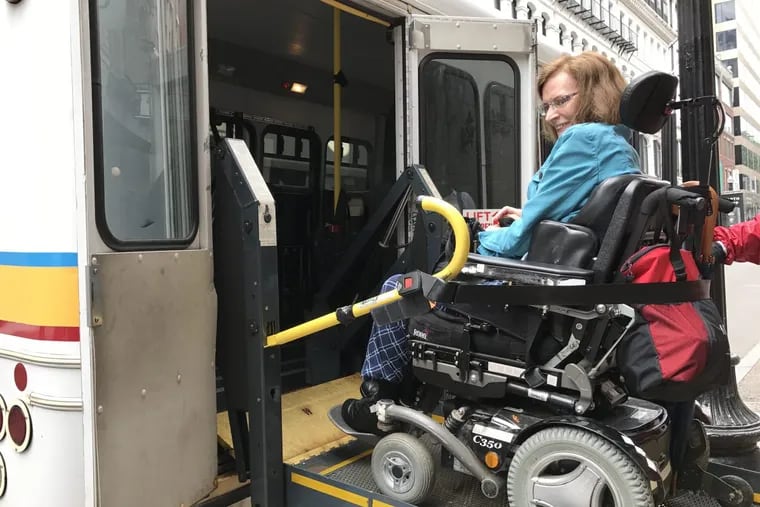 Elizabeth Dean-Clower boards a paratransit vehicle in Boston. A physician and disability advocate, she has been following the MBTA’s experiment with using ride-hail vehicles to make it easier for people with disabilities to get around.