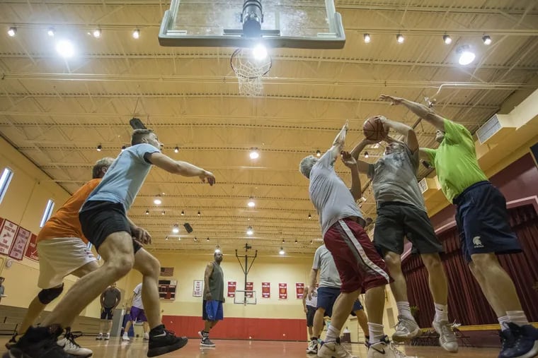 This group of players have been playing pickup basketball games for over 35 years. They are shown on June 20, 2018. CHARLES FOX / Staff Photographer