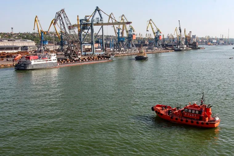 A Russian vessel (top left) prepares to depart from the Mariupol Sea Port in Mariupol, in territory under the government of the Donetsk People's Republic, eastern Ukraine, on May 31. It marked the first time that a commercial ship used the port of Mariupol since the start of the Russian military action in Ukraine.
