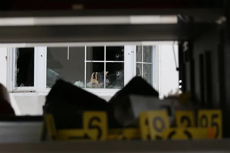 Framed by a Crime Scene Unit truck, the house in the 3700 block of North 15th Street in Tioga where Maurice Hill allegedly shot and wounded six police officers during an hours-long standoff Wednesday, Aug. 14, 2019, is pictured three days later.
