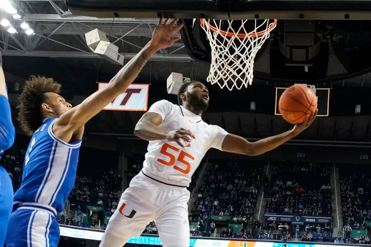 Miami guard Wooga Poplar (55) drives past Duke center Dereck Lively II (1) during the first half of an NCAA college basketball game at the Atlantic Coast Conference Tournament in Greensboro, N.C., Friday, March 10, 2023. (AP Photo/Chuck Burton)