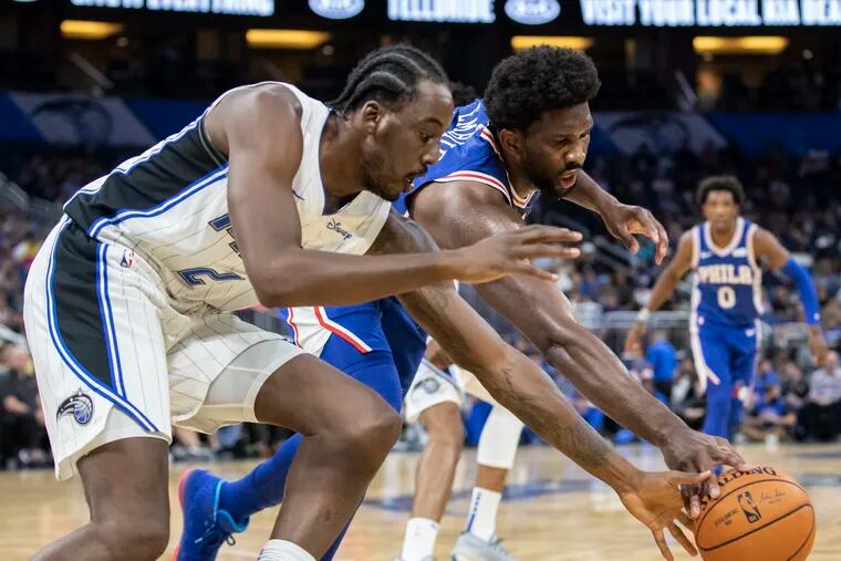 Orlando Magic forward (2) Al-Farouq Aminu and Philadelphia 76ers center Joel Embiid fight for the ball during the first half of a preseason NBA basketball game in Orlando, Fla., Sunday, Oct. 13, 2019. (AP Photo/Willie J. Allen Jr.)