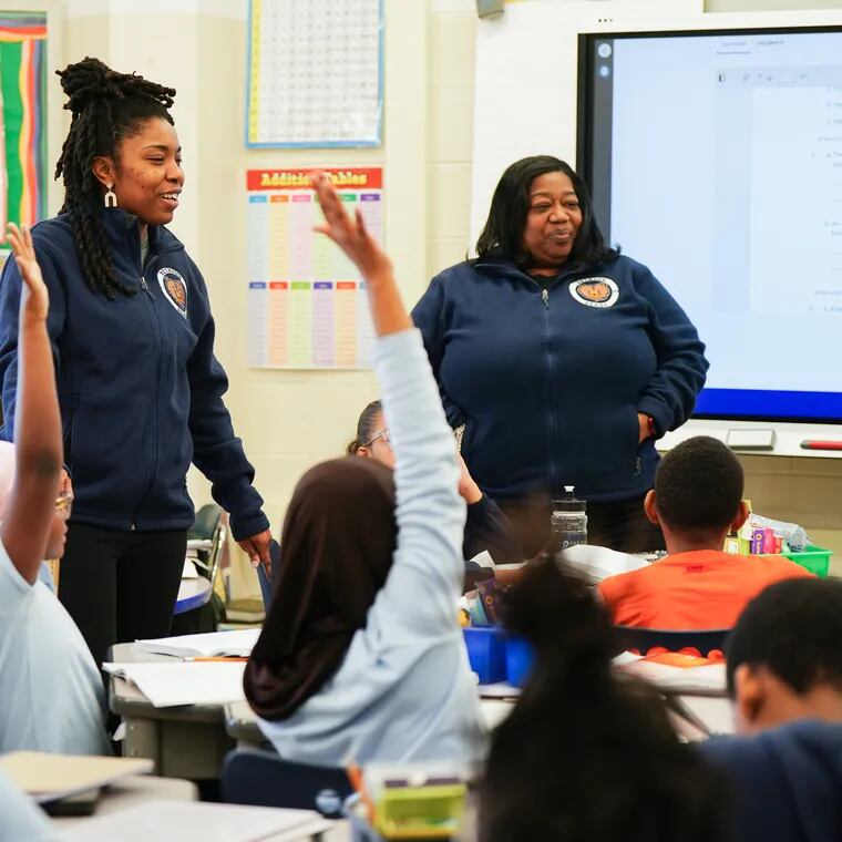 Takia McClendon (left) in her classroom at Bethune Elementary School in Philadelphia, Friday, Feb. 16, 2024. McClendon is considering leaving the teaching job she loves because of the low pay. "I’ve made more money selling bikes and sneakers."