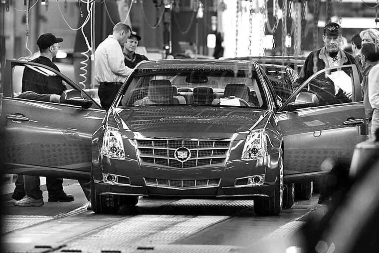 A General Motors Co. Cadillac sits on the assembly line at GM's Grand River Assembly Plant in Lansing, Mich. North American sales helped the firm.