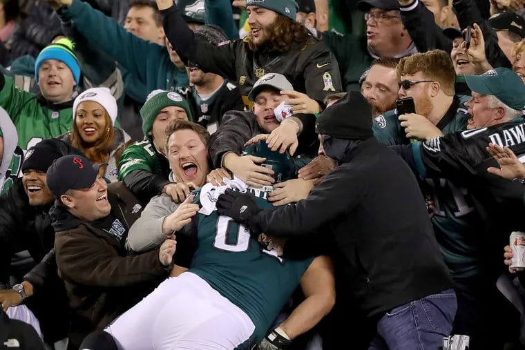 Eagles fans celebrate as Stefen Wisniewski, jumps into the stands after Alshon Jeffery scored in the 4th quarter against the Vikings in the NFC Championship game Sunday.