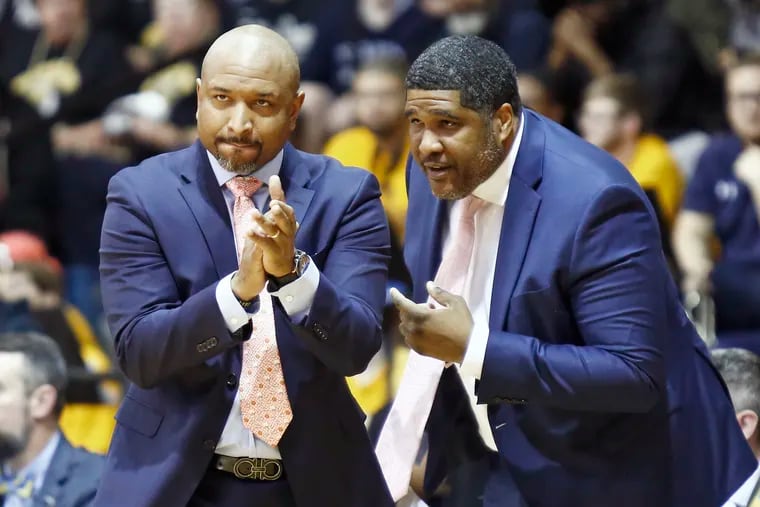 Assistant coach Kenny Johnson (right) talks to La Salle coach Ashley Howard during a game against Virginia Commonwealth in January.
