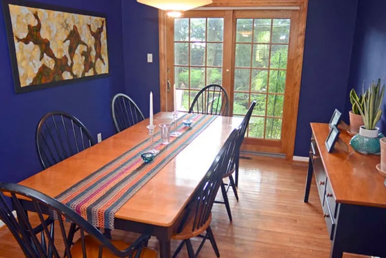 The dining room is Americana-furnished; Griffith installed the doors to open up the view of the backyard garden.