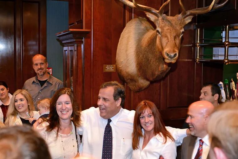 Gov. Chris Christie (center) poses with customers as he campaigns in support of congressional candidate Tom MacArthur (right) at Mastoris Diner in Bordentown on October 23, 2104. ( TOM GRALISH / Staff Photographer )