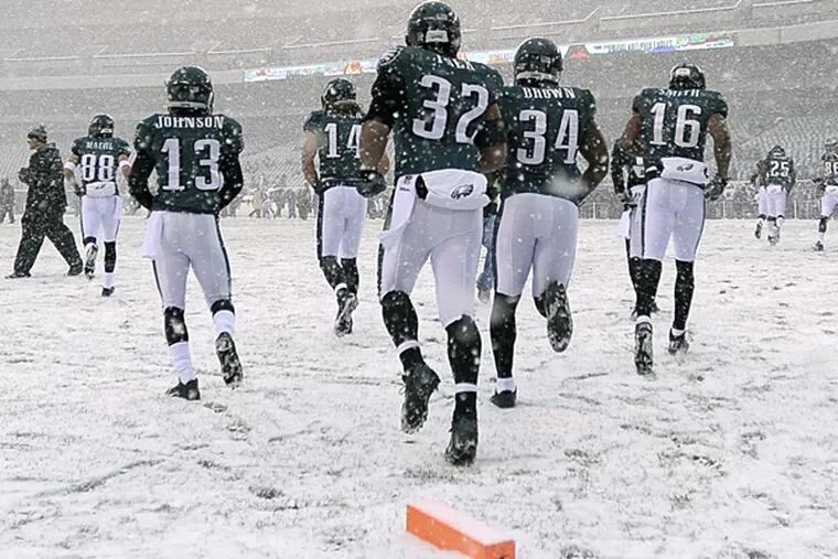 The Eagles warm up before their game against the Lions. (Michael Perez/AP)