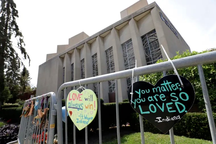 Signs hang on a fence surrounding the Tree of Life synagogue in Pittsburgh in 2019.