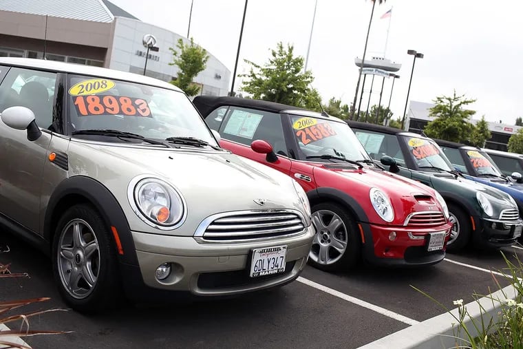 Used cars are displayed on a sales lot in June in San Rafael, California.