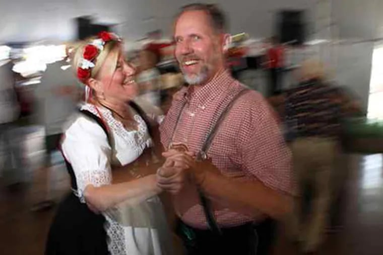 Taimi and Bob Young of Marmora, N.J., wore traditional dirndl and lederhosen to the 138th annual Cannstatter Volksfest. (Laurence Kesterson / Staff Photographer)