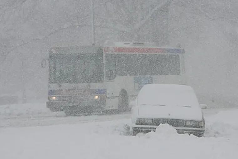 A SEPTA bus passes a stranded auto near the Museum of Art on Wednesday. (Michael S. Wirtz / Staff Photographer)