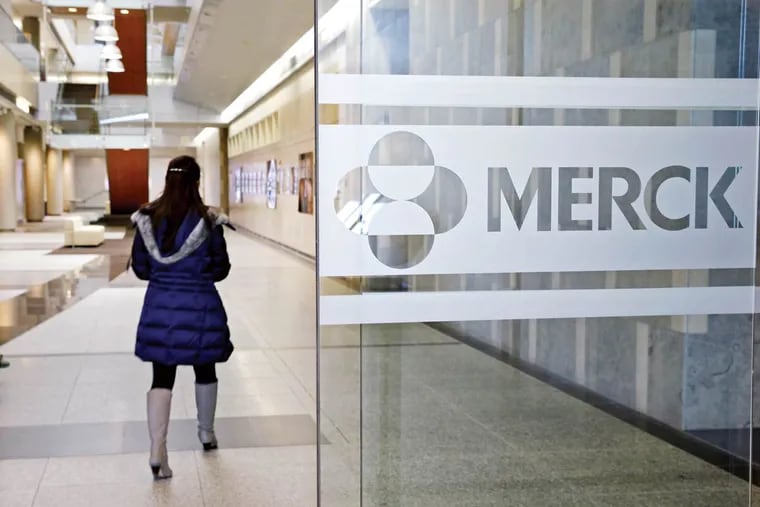 In this Thursday, Dec.18, 2014, photo, a person walks through a Merck & Co. building in Kenilworth, N.J. Merck systems were subject to a ransomware attack this morning and the company and employees were advised to disconnect their computers and avoid talking to the media.