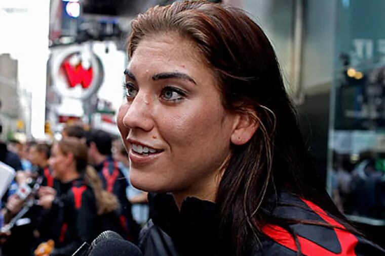 Hope Solo and the rest of the U.S. Women's World Cup team returned home Monday. (Craig Ruttle/AP)