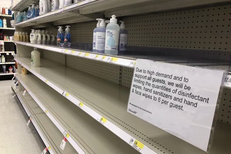 A sign notifies customers of a quantity limit as shelves are mostly bare of soap and hand sanitizer bottles at the Target on City Avenue in West Philadelphia on Wednesday, March 11, 2020. Customers have been buying soap and hand sanitizer due to the ongoing coronavirus pandemic.