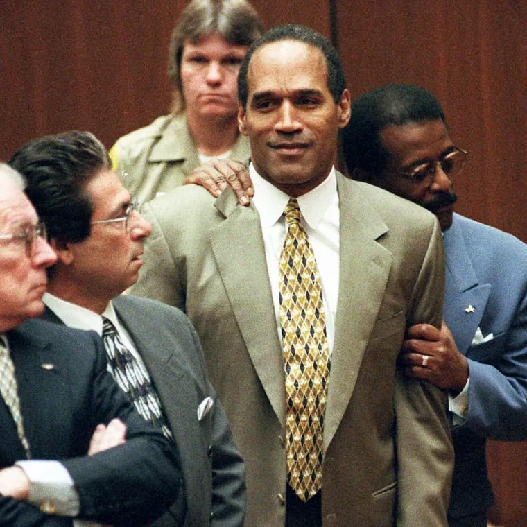 In this Oct. 3, 1995 file photo, attorney Johnnie Cochran Jr. embraces O.J. Simpson as the not guilty verdict is read in a Los Angeles courtroom during his trial in Los Angeles. Defense attorneys F. Lee Bailey, left, Robert Kardashian look on.