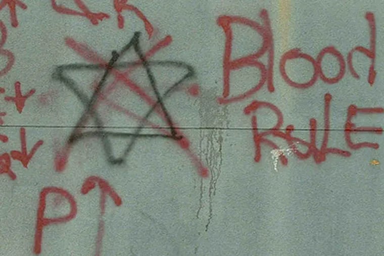 Graffiti in Irvington, N.J. Authorities say the six-point star, a Crips symbol, is crossed out by a Bloods member in a sign of disrespect.