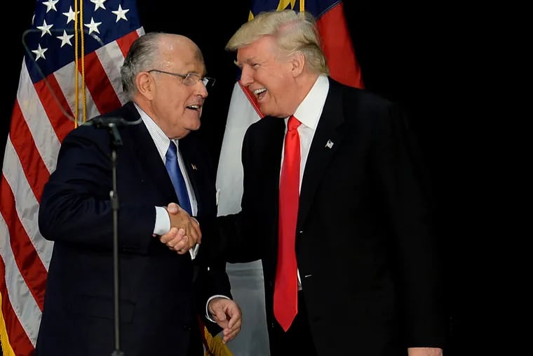Former New York City mayor Rudy Giuliani, left, welcomes Republican presidential candidate Donald Trump on stage during a campaign rally on Aug. 18, 2016, at the Charlotte Convention Center in Charlotte, N.C.