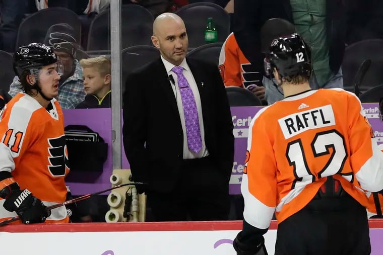 Then-Flyers assistant Ian Laperriere giving instructions to Michael Raffl during a game in November 2019.