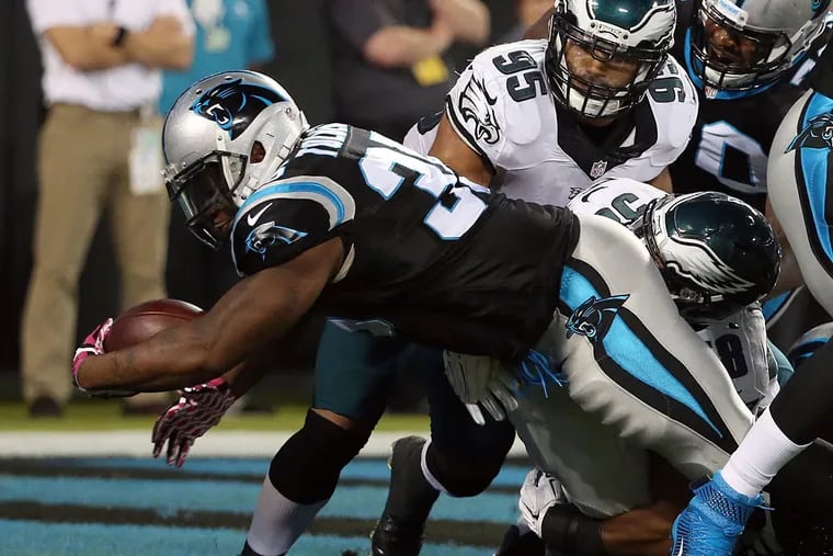 The Panthers' Mike Tolbert scores a touchdown run past Mychal Kendricks and Jordan Hicks.