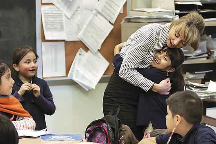 1st grader Mirian Solares-Tlapaya ran over to hug Daphne Owen when Owen entered the classroom during the after-school tutoring and wellness program at Southwark Elementary School in Phila. on January 31, 2013.  ( ELIZABETH ROBERTSON / Staff Photographer )