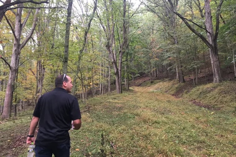 Kem Parada, of Finders Keepers, heads uphill in Dents Run, the Elk County location where he and his father believe gold is buried.