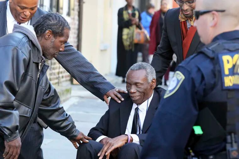 John Pinckney, father of the Rev. Clementa Pinckney, is greeted after leaving the courthouse.