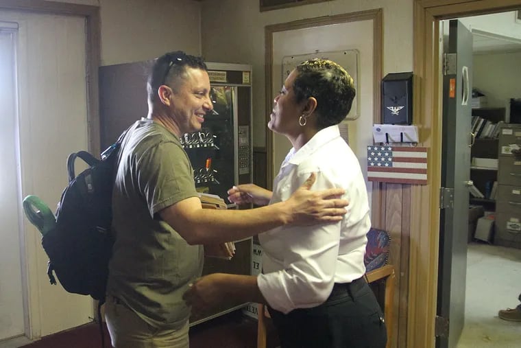 In this June 27, 2014 photo, Navy veteran Rik Villarreal greets American Legion official Verna Jones at the El Paso American Legion in El Paso, Texas. The American Legion is hosting crisis centers in different cities to help veterans get doctor’s appointments and benefits from the Department of Veterans Affairs.  (AP Photo/Juan Carlos Llorca)