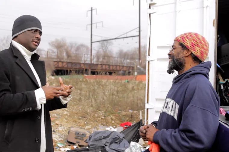 Rel Dowdell (left) speaks with Ogbonna Hagins in the film “Where’s  Daddy?” Hagins, a former schoolteacher, is now a self-employed scrapper and junk collector who says the work has freed him up to be a better father.