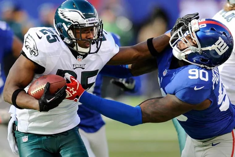 Eagles running back LeSean McCoy (25) stiff-arms New York Giants defensive end Jason Pierre-Paul (90) during the first half of an NFL football game on Sunday, Dec. 30, 2012, in East Rutherford, N.J. (Bill Kostroun/AP file)