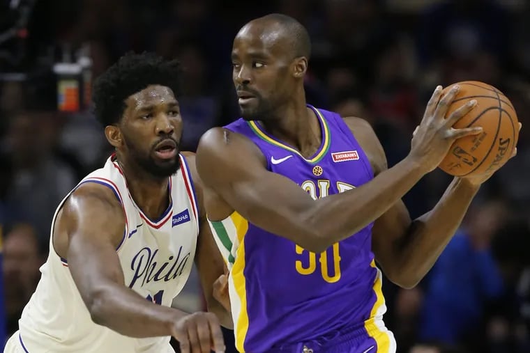 Sixers center Joel Embiid defends against New Orleans Pelicans center Emeka Okafor in a February game.