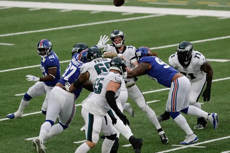 Eagles quarterback Carson Wentz throws the football while getting pressured against the New York Giants on Sunday, November 15, 2020.