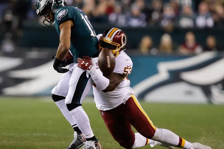 Washington Redskins inside linebacker Zach Brown forces Eagles wide receiver Golden Tate to fumble in 2018.