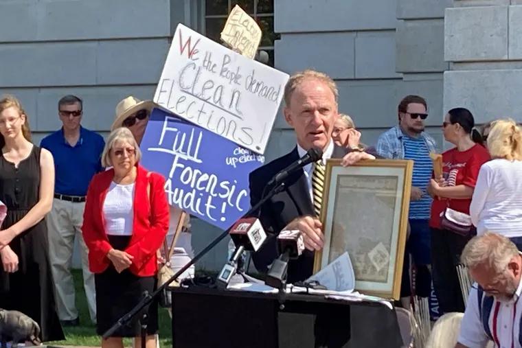 Jefferson E. Davis, spokesman for a group pushing for a broad review of the 2020 presidential election in Wisconsin, holds up a copy of the Declaration of Independence before leading a group of about 100 people into the state Capitol offices of Republican state leaders asking them to sign subpoenas for access to voting machines, ballots and other election material, on Sept. 10, 2021, in Madison, Wis.