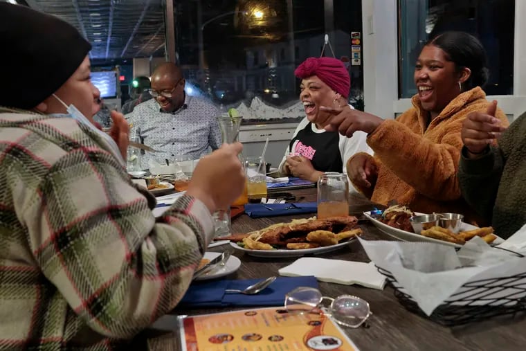 (From left) Aijeé Austin of Bryn Mawr, Creole instructor Joel Leon, Nicole Austin-Hall of Wayne, and Amanda Vital of Phila. laugh as they speak and learn Haitian Creole during a class at Gou! restaurant in Phila., Pa., on Tues., Feb. 07, 2023.
